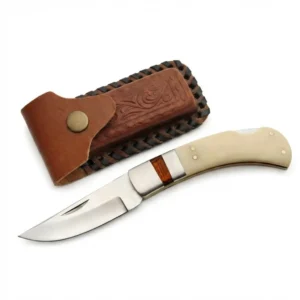 Close-up of a stainless steel blade on a bone handle heritage pocket knife with brown sheath