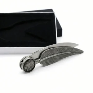 Closed feather shaped knife showing detailed metal texture and chief portrait