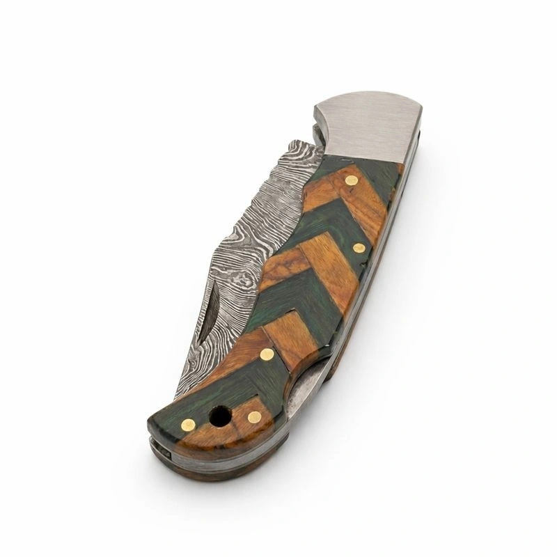 damascus-wood-folding-knife-closed-filework-spine Closed Damascus wood folding knife displaying decorative spine filework and brass pins.