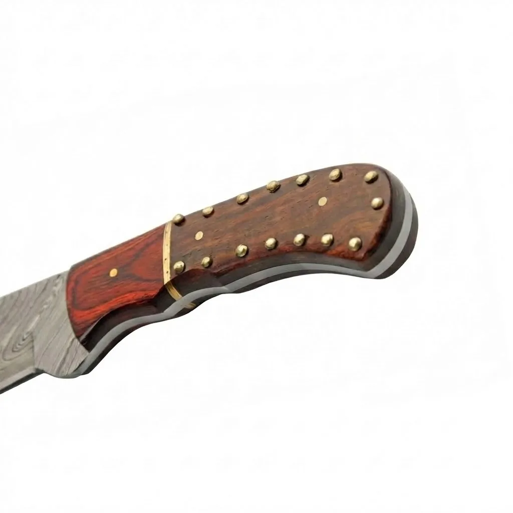 damascus-skinner-knife-studded-wood-handle Close-up of a studded rosewood handle on a Damascus fixed blade knife with brass pins.