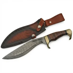 Handmade Damascus Cleaver Knife laying next to its matching embossed leather sheath.