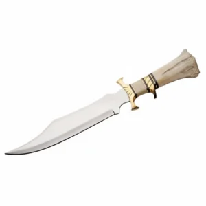 Close up of handcrafted camel bone handle and brass guard on a bowie knife.