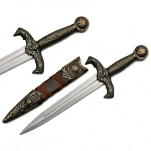 Ornate stainless steel collector dagger with brass finished guard and pommel.