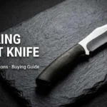 Trailing point knife with curved blade on dark stone background for uses, pros and cons, and buying guide.